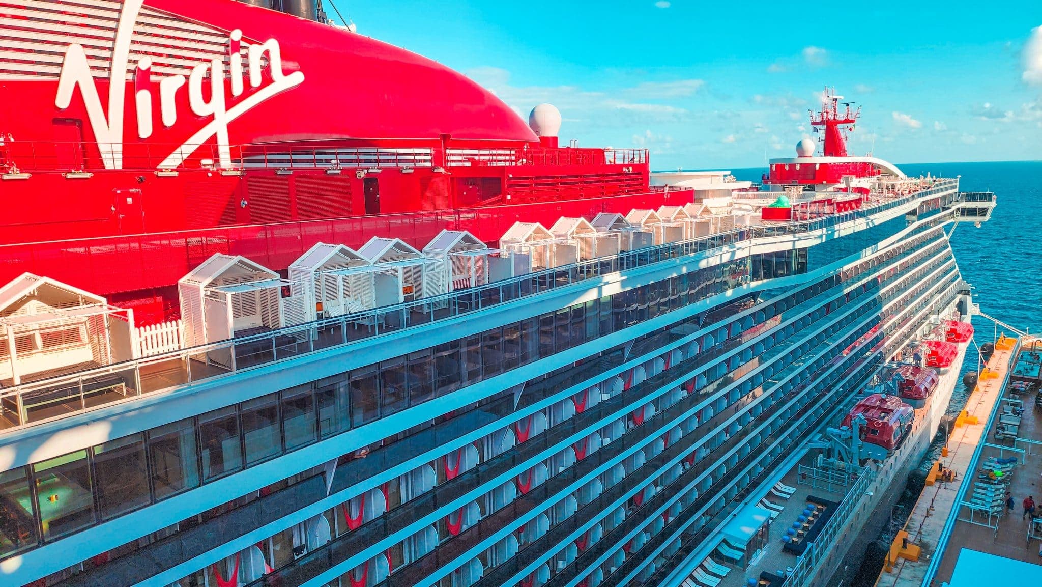 The hull and balconies of a Virgin Voyages ship