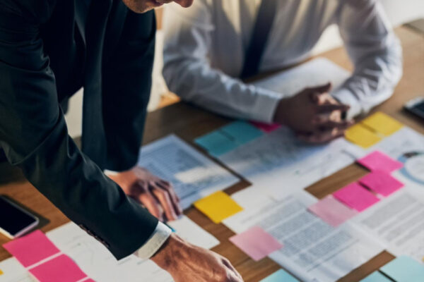 Business men partner and notes with documents graphs planning