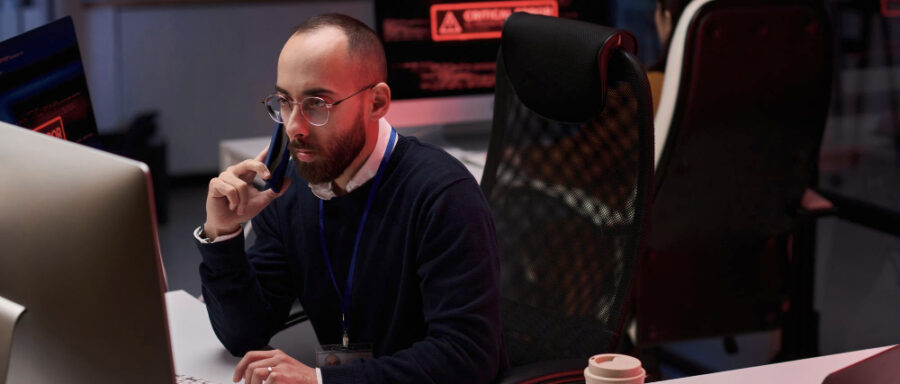 Man using computer with multiple monitors
